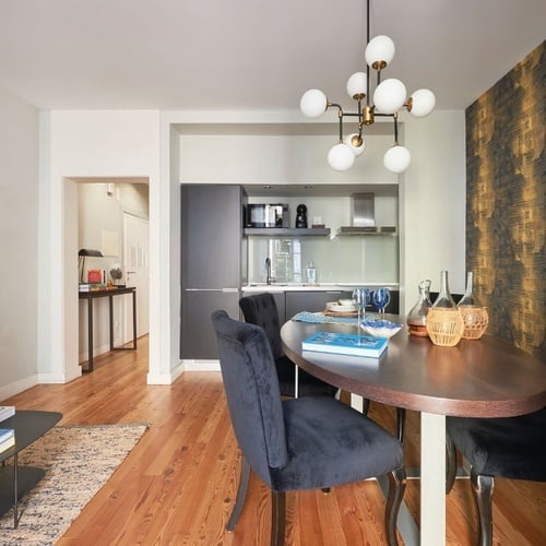 a dining room with a glass table and chairs