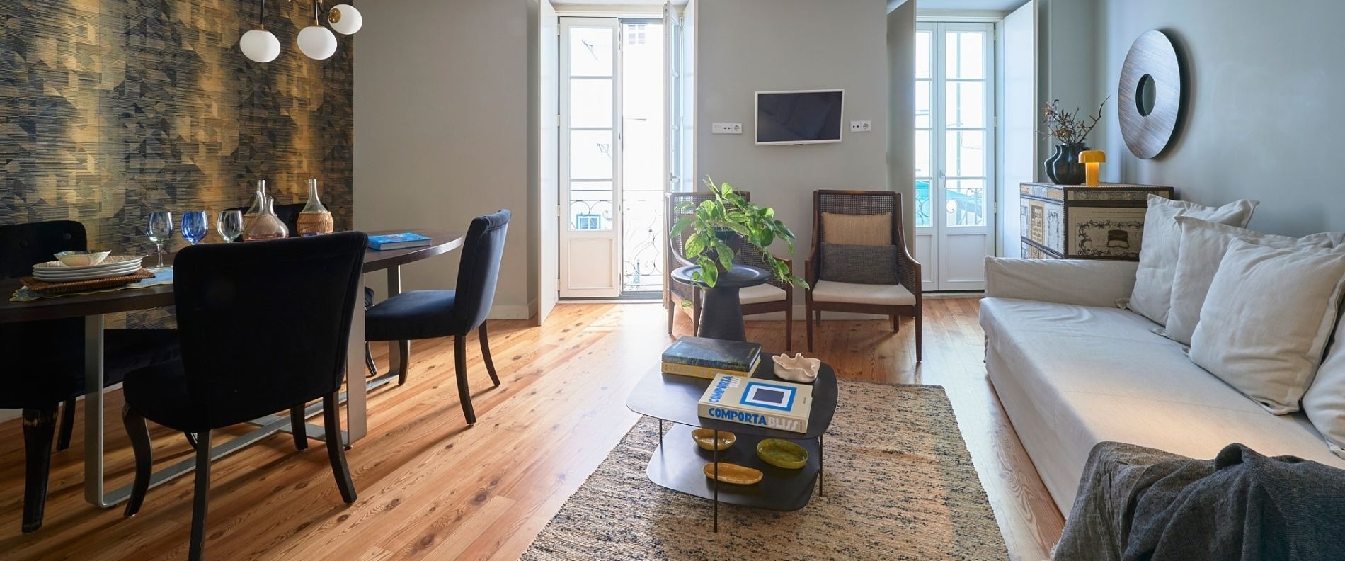 a kitchen with a table and chairs and a painting on the wall