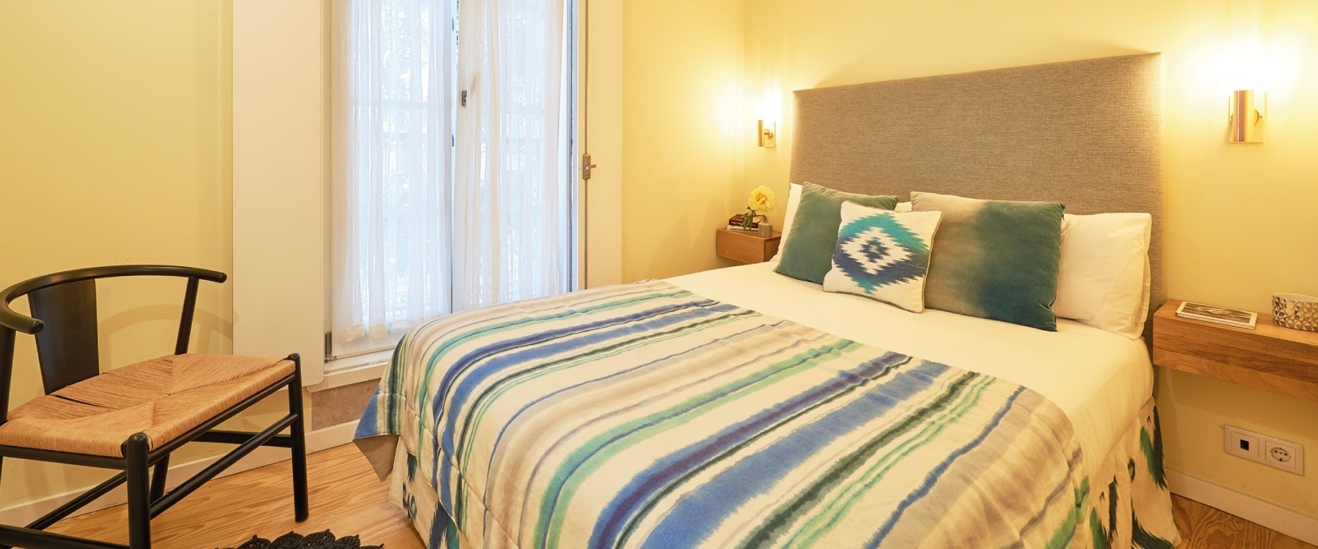 a bedroom with a floral wallpaper on the wall