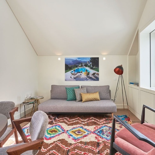 a living room with a table and chairs and a flat screen tv