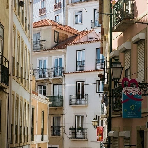 a row of buildings with balconies and a sign that says ' boutique ' on it