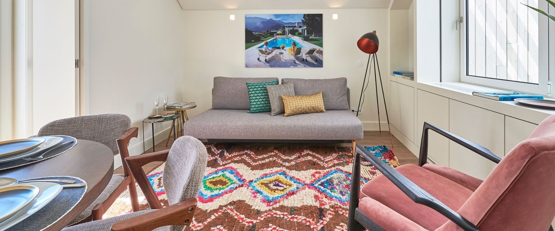 a living room with a couch and a painting on the wall