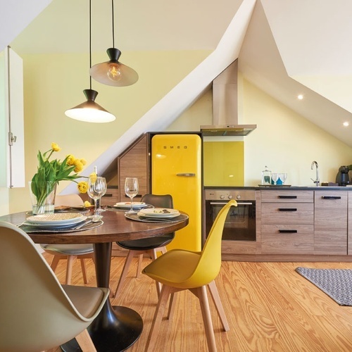 a kitchen with a yellow smeg refrigerator