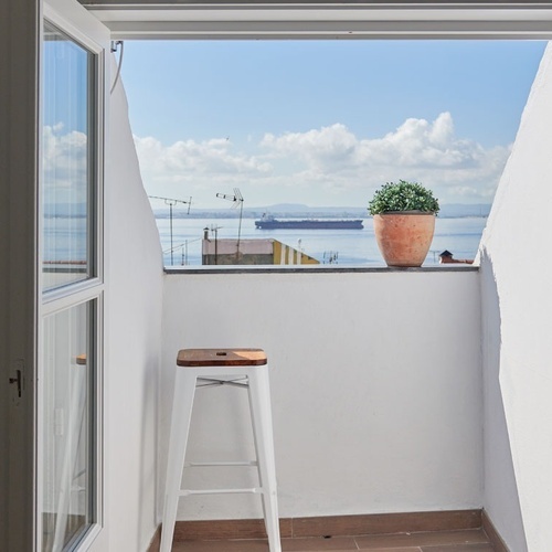 a balcony with a view of a body of water