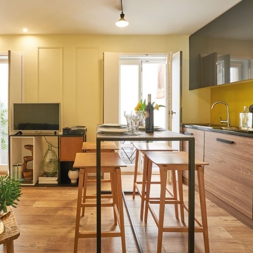 a kitchen with wooden cabinets and black counter tops