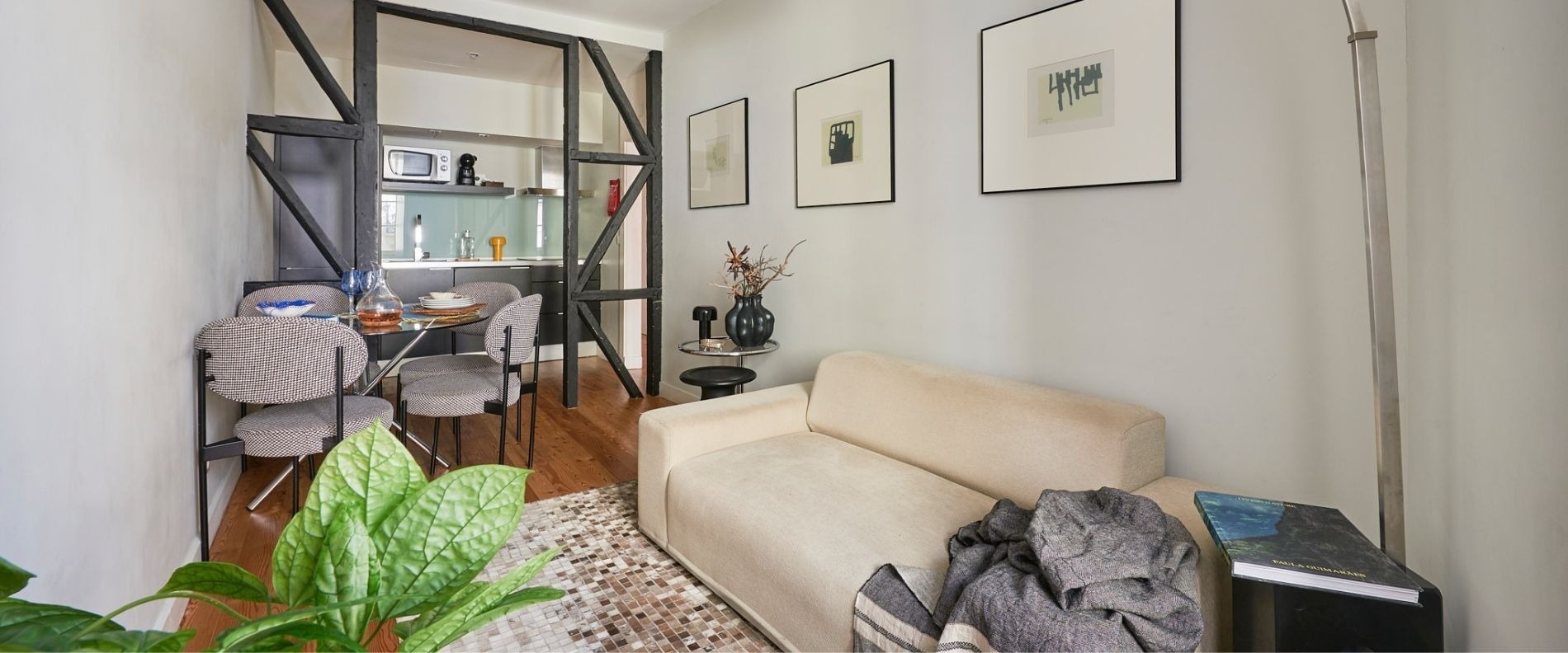 a living room with a couch and a painting on the wall