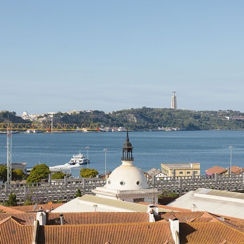 a large body of water with a bridge in the background