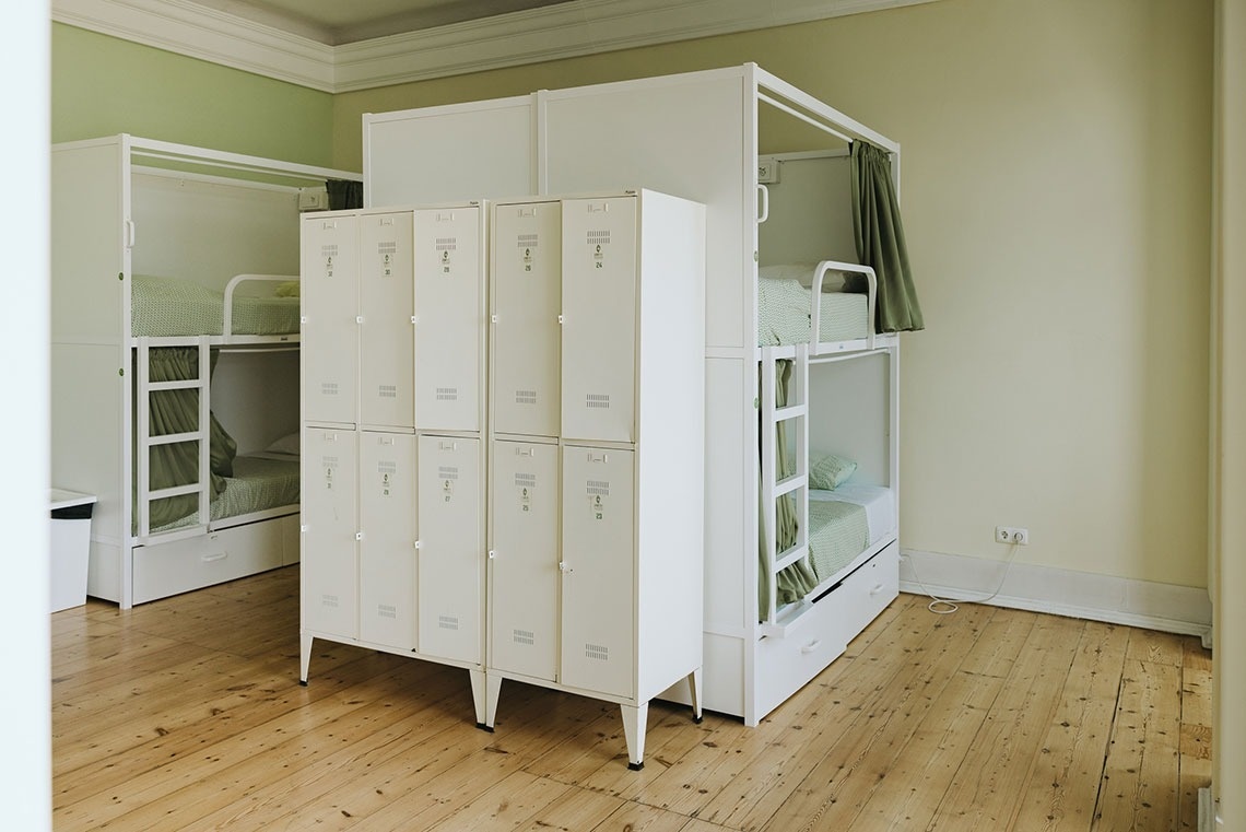 a room with bunk beds and lockers with the numbers 1 through 12 on them