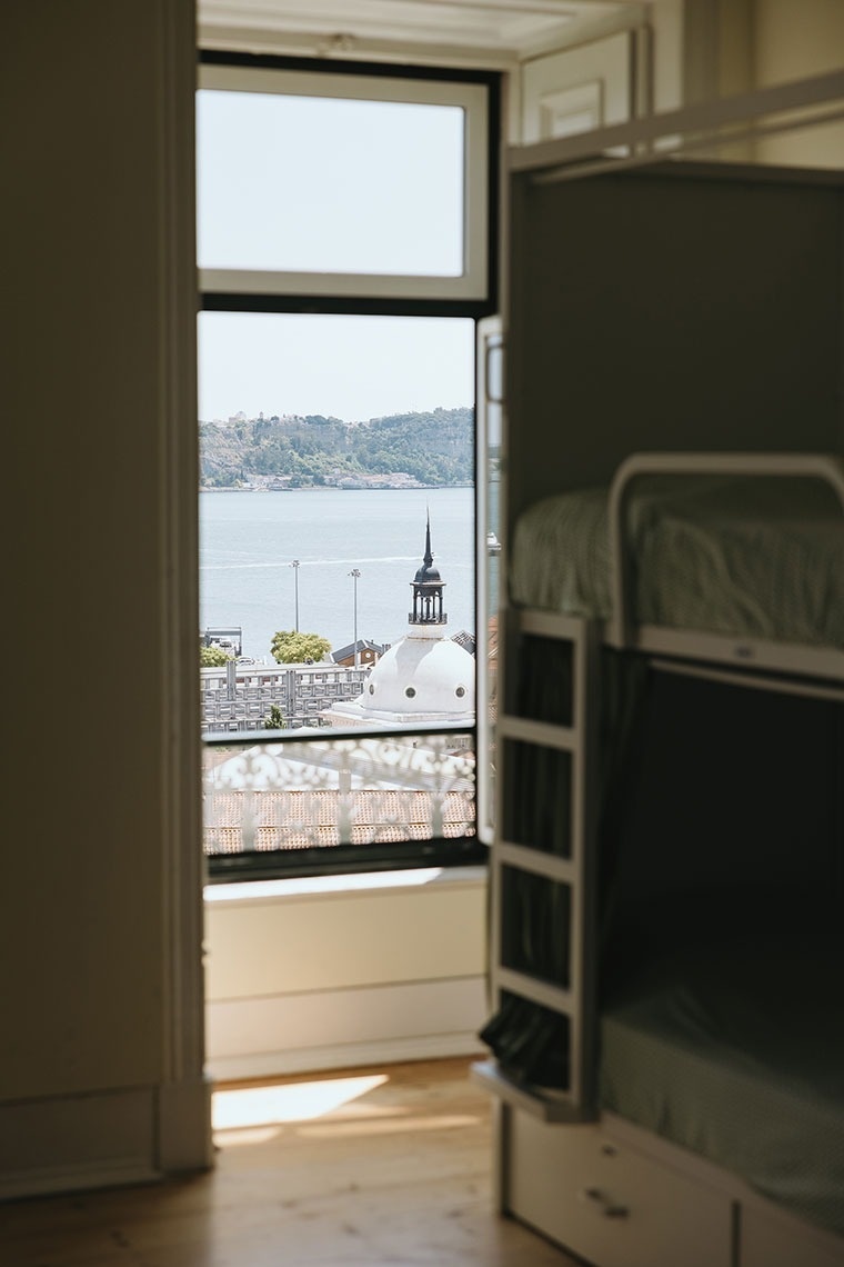 a bunk bed with a view of a body of water