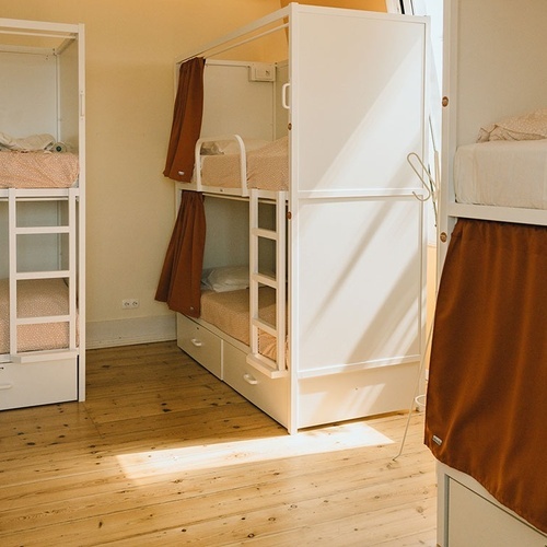 a row of bunk beds in a dorm room