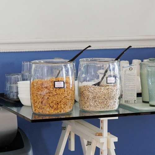 two jars of cereal and oatmeal on a glass table