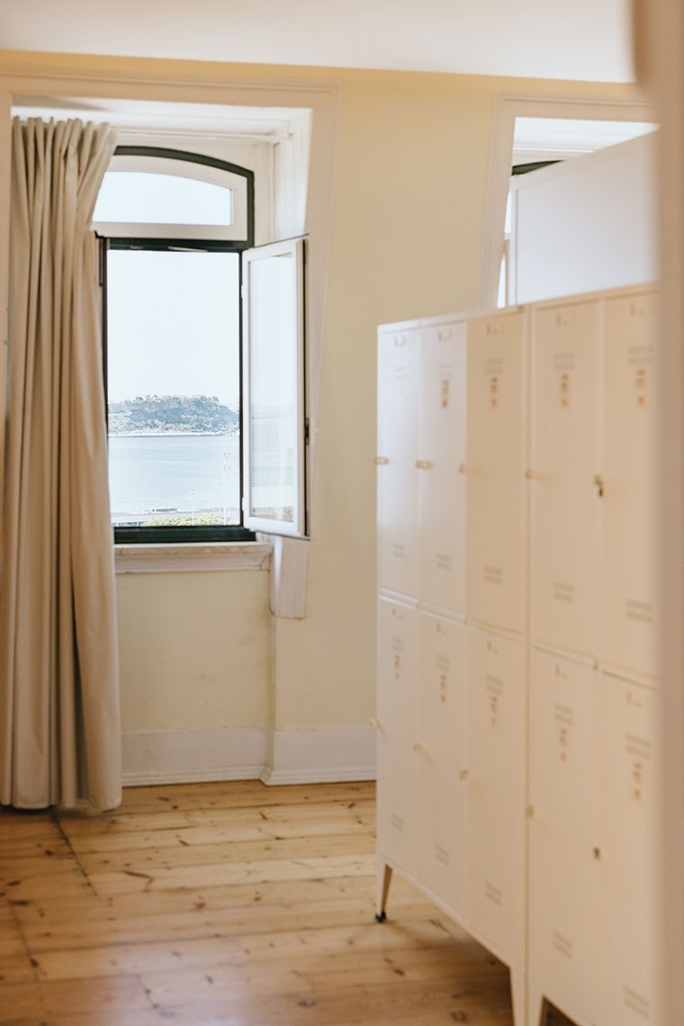 a room with lockers and a window with a view of the ocean