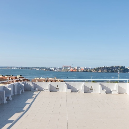 a rooftop with a view of a body of water