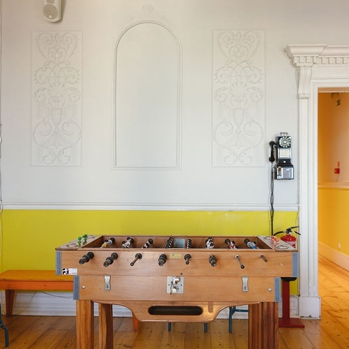a foosball table in a room with a yellow wall