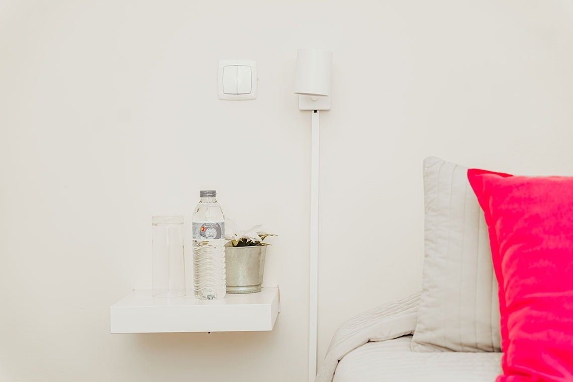 a bottle of aquafina water sits on a white shelf