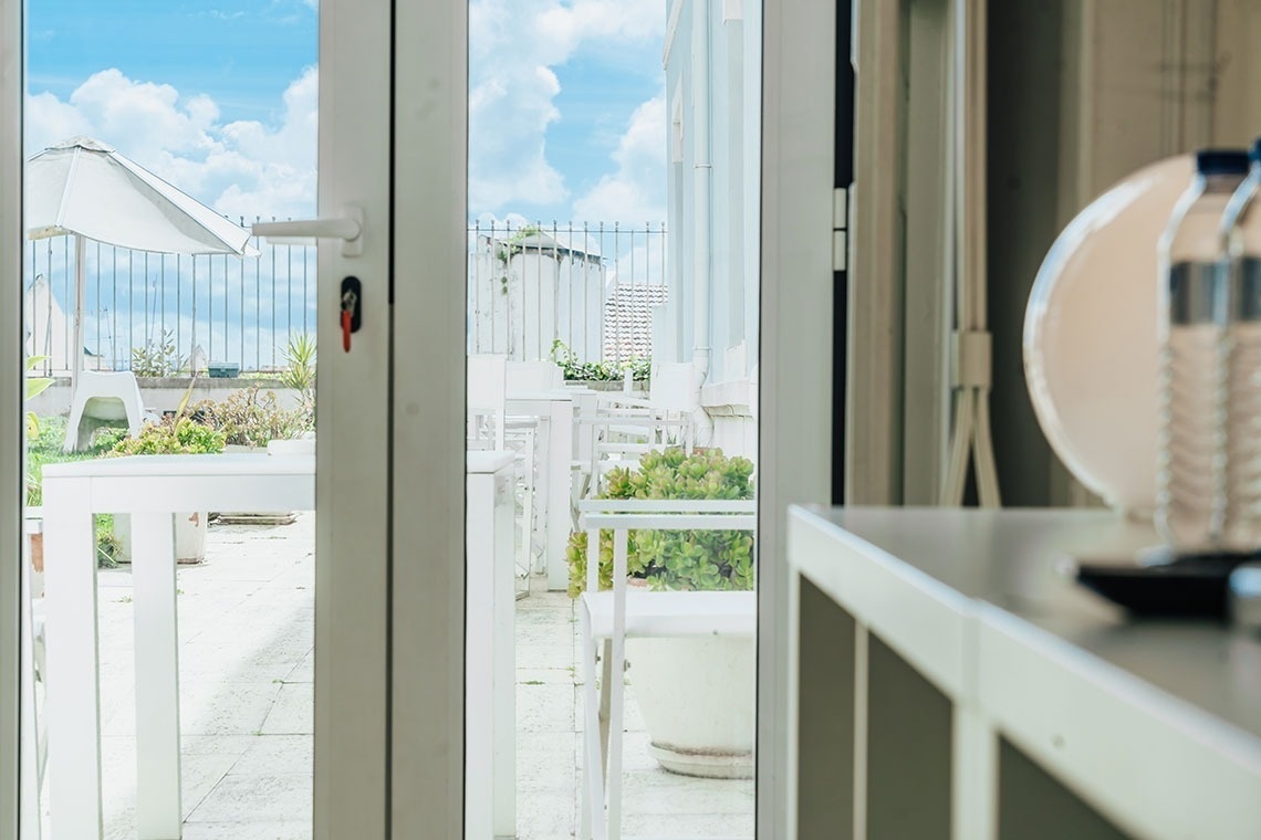 a view of a balcony through a sliding glass door
