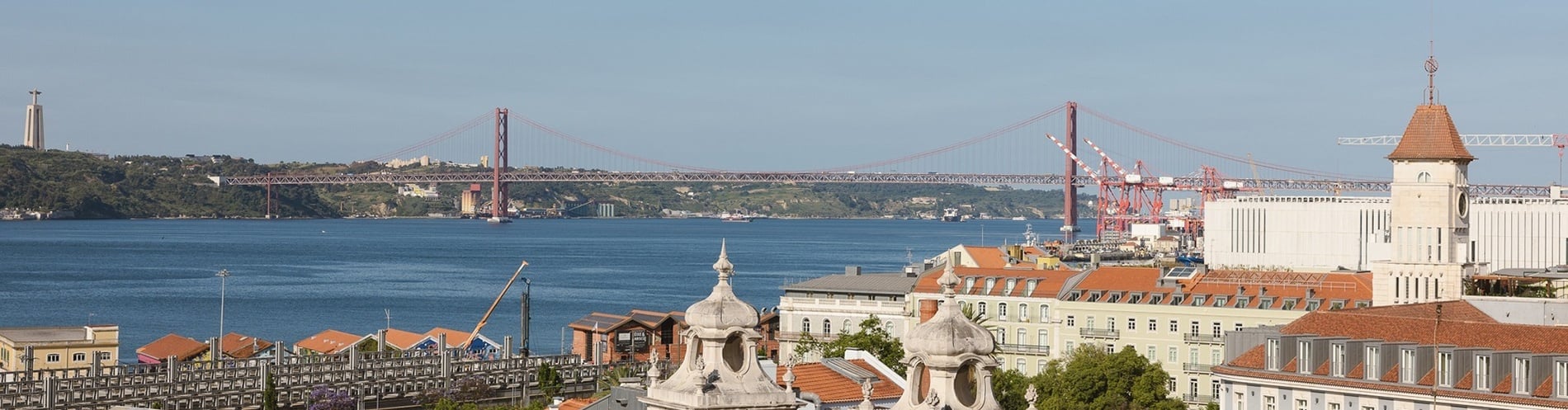 a bridge over a body of water with buildings in the foreground