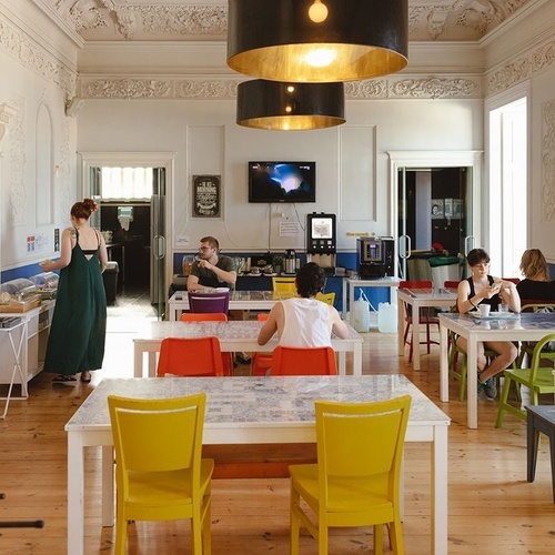 people sitting at tables in a room with a sign that says ' a ' on it