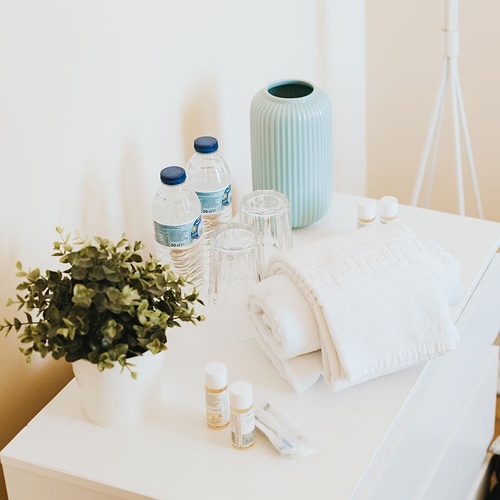 two bottles of aquafina water sit on a white table