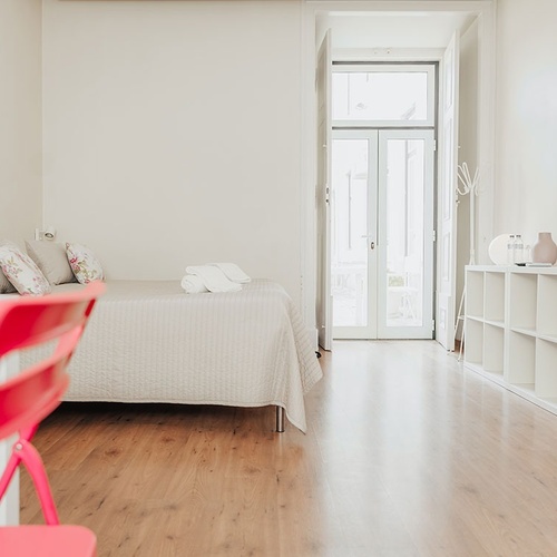 a bedroom with a bed and a television with a vase that says ' i love you ' on it