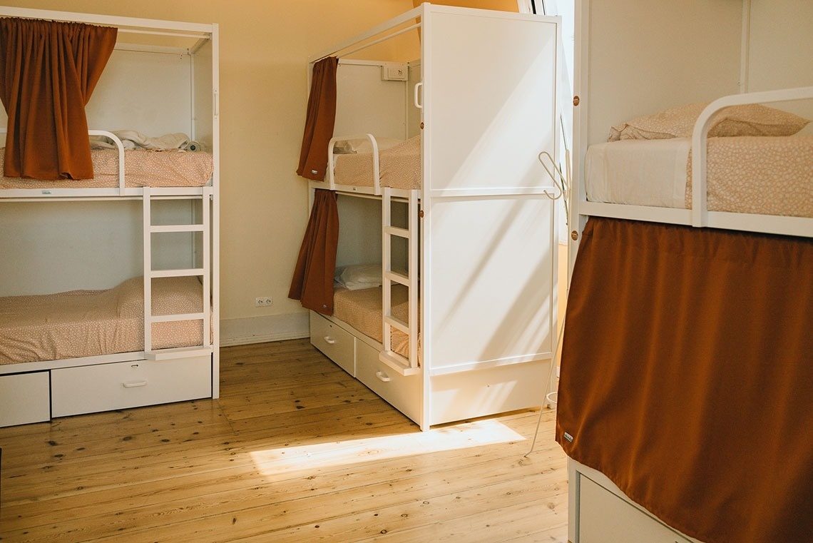 a row of bunk beds in a dorm room