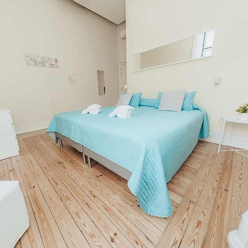 a bedroom with a bed with a blue blanket on it