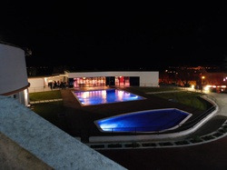 Piscinas iluminadas y vistas nocturnas en Luna Corporativa.
