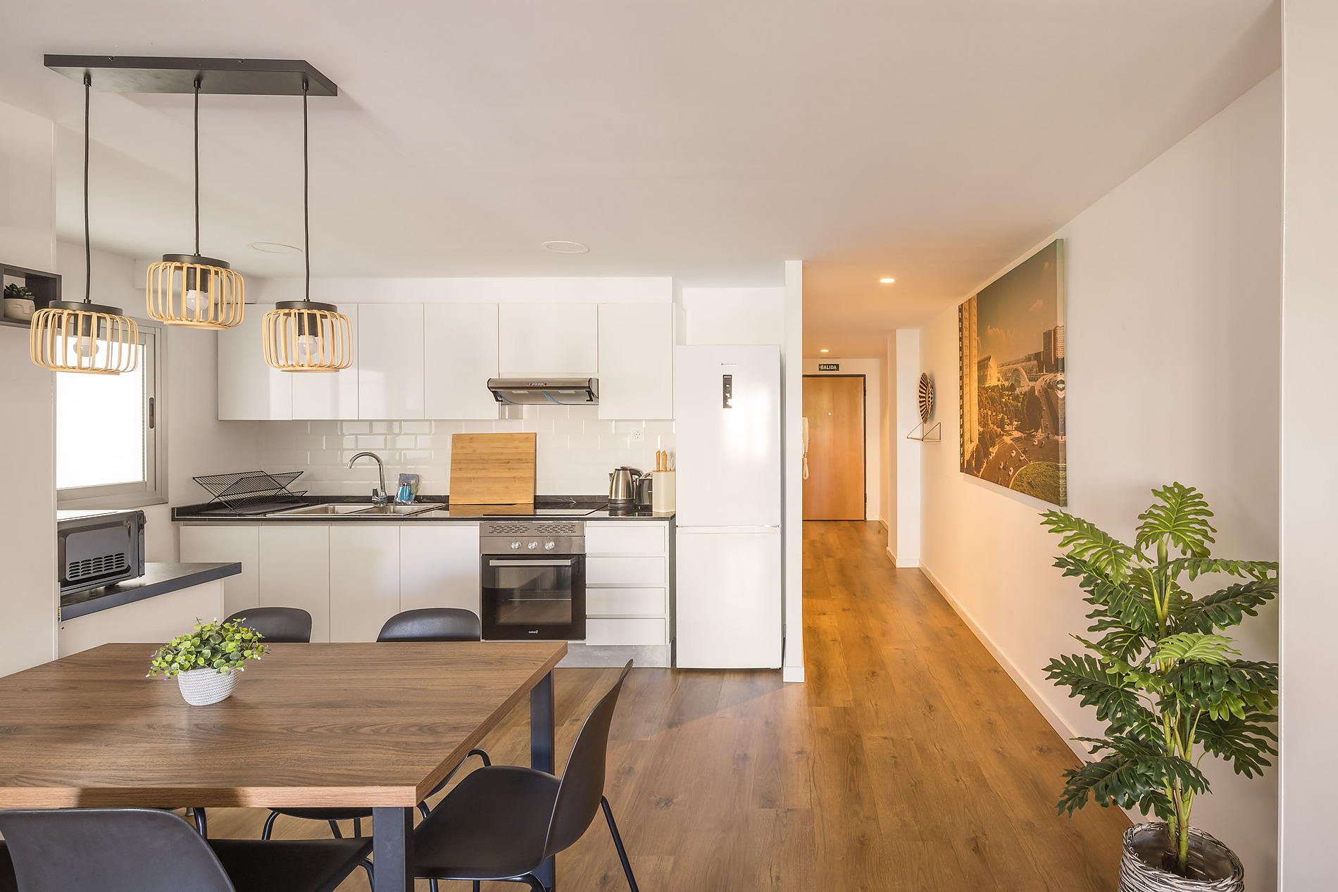 Modern hotel dining area and kitchen with island, a Macflats: Ciudad de las ciencias, and wood flooring.