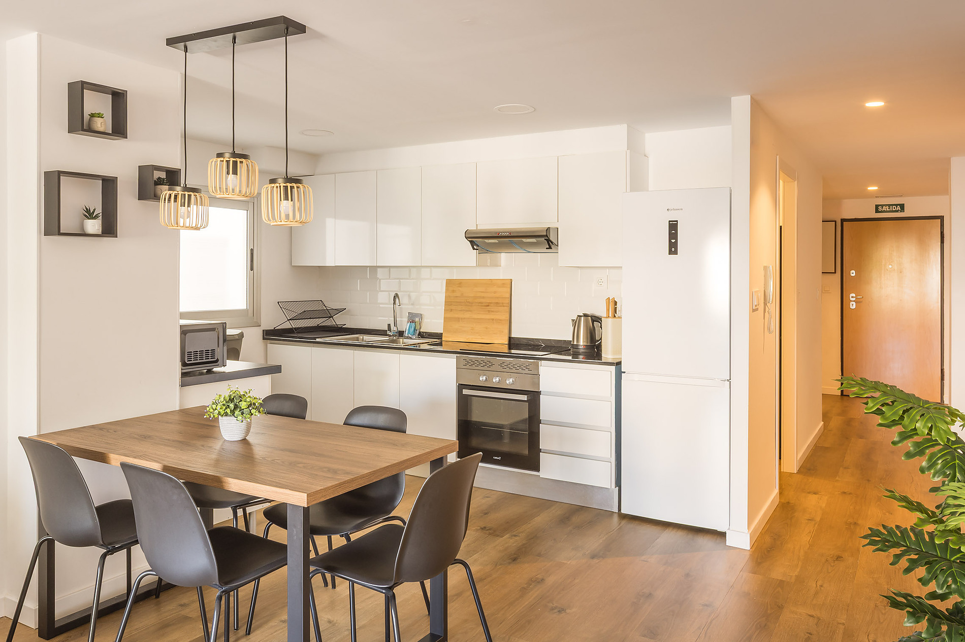 Modern hotel kitchen and dining area with contemporary furniture and amenities. Macflats: Ciudad de las ciencias