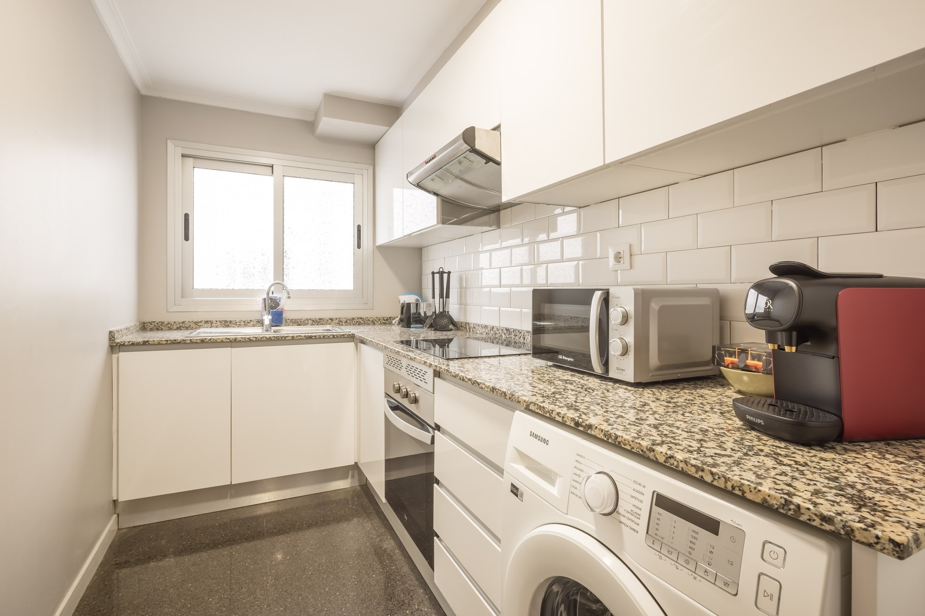 Modern kitchen with appliances at Macflats Valencia. Book your stay today!