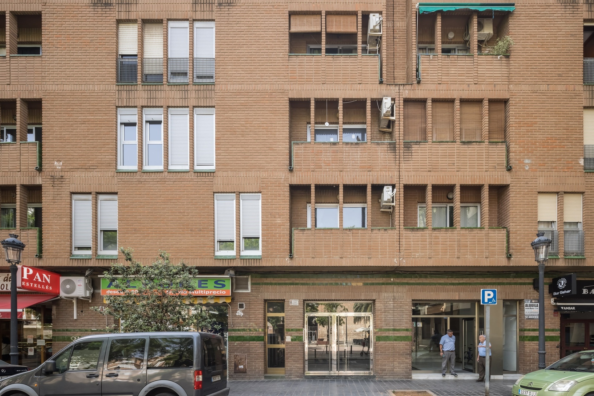 Apartment building facade with shops and apartments. Macflats Valencia.