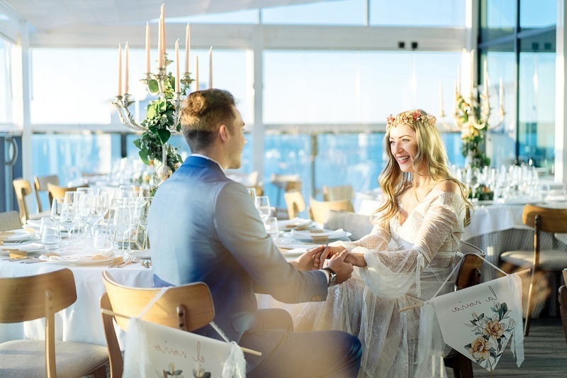 a room with tables and chairs and a view of the city