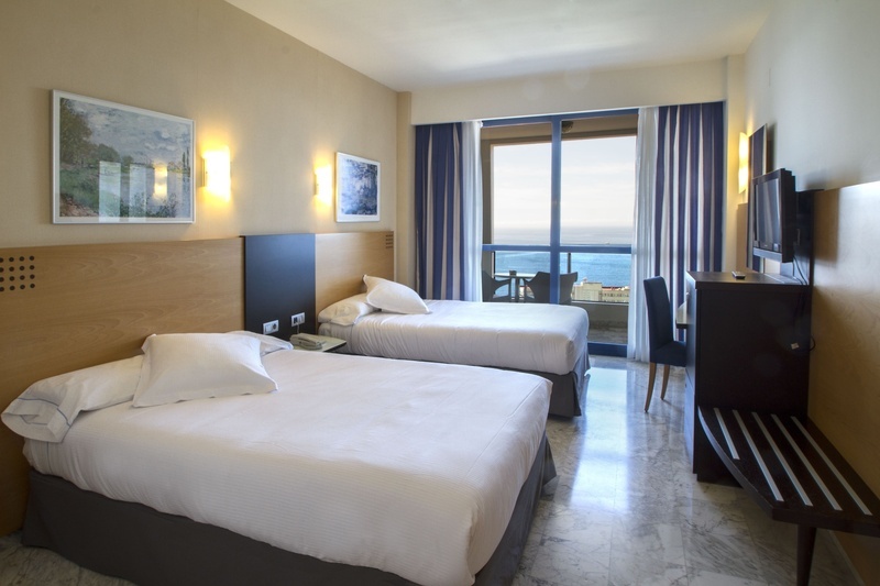 una habitación de hotel con dos camas y una televisión