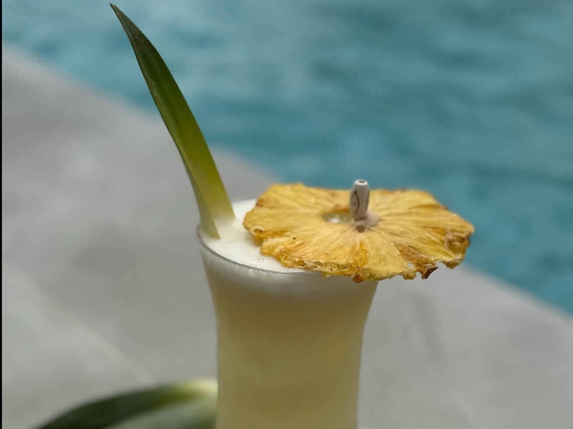 a drink with a pineapple slice on top of it