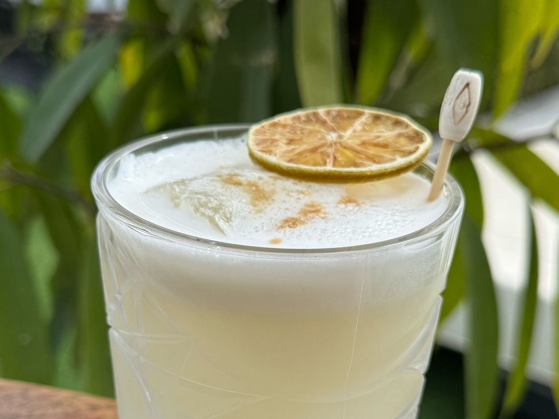a close up of a drink with a slice of lime on top