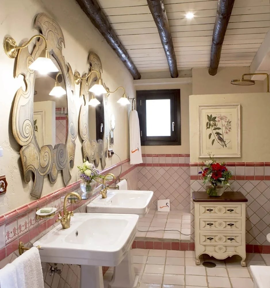 a bathroom with two sinks a mirror and a dresser