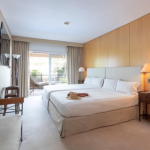 Chambre d'hôtel avec deux lits, terrasse et Suites del Mar Fenals Apartments.