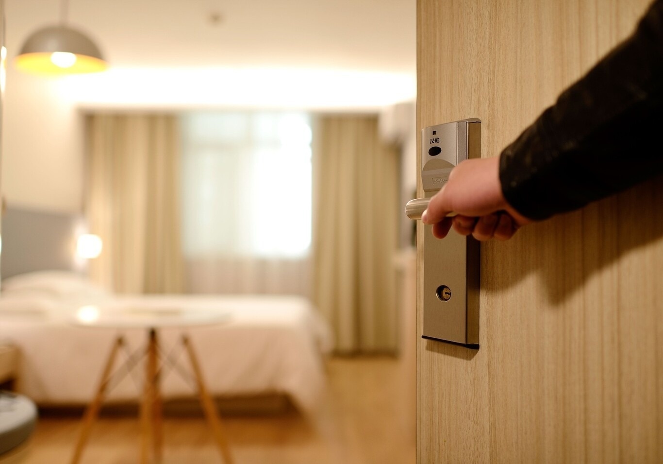 a hotel room with two beds and a flat screen tv