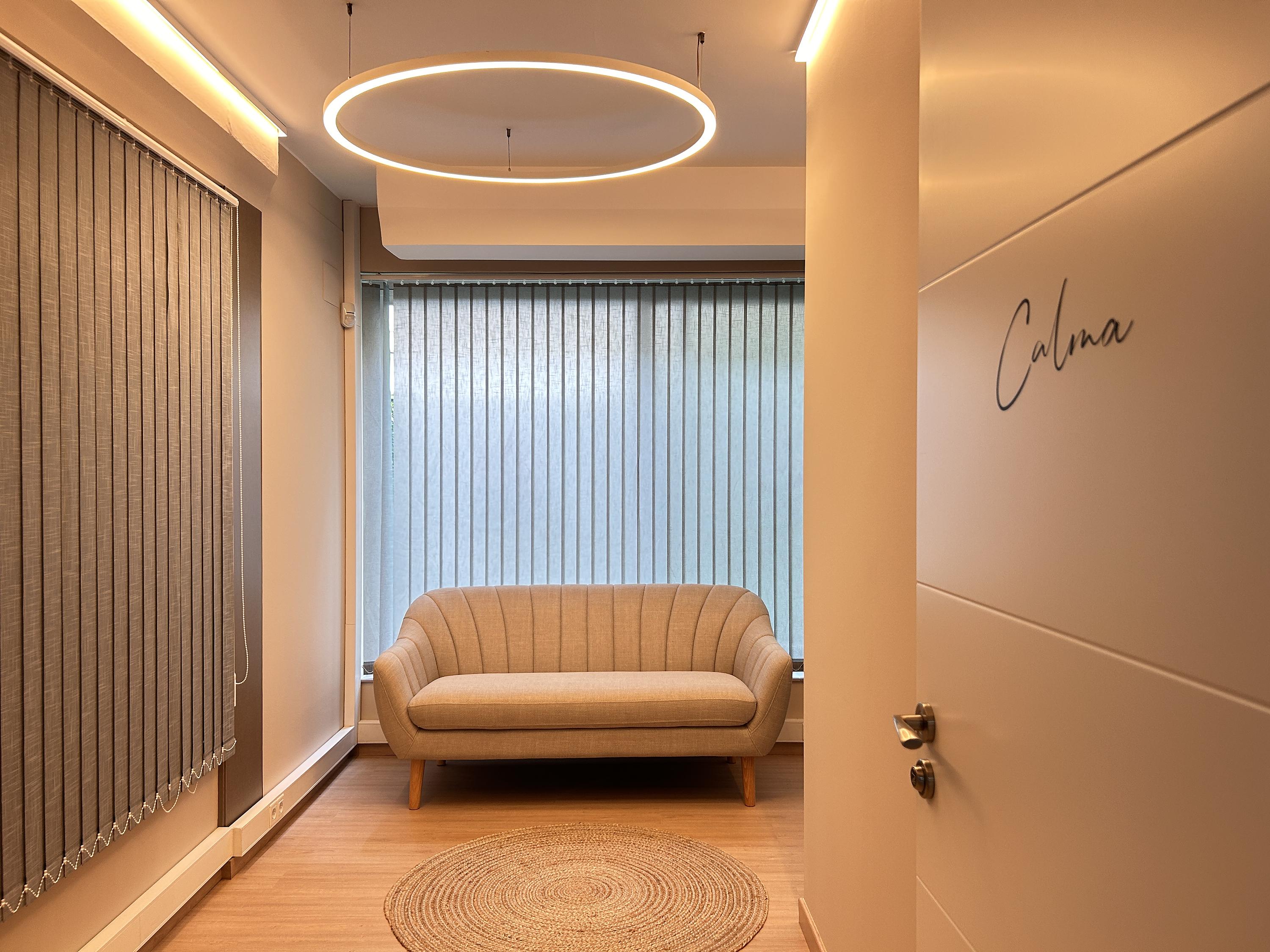 Sofa and rug in the Calma Maria del Mar lounge, modern lighting and door with a minimalist design.