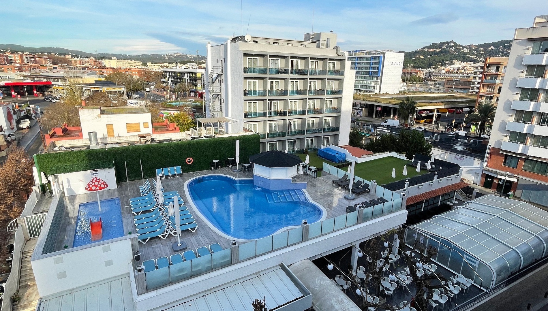 an aerial view of a hotel with a large swimming pool