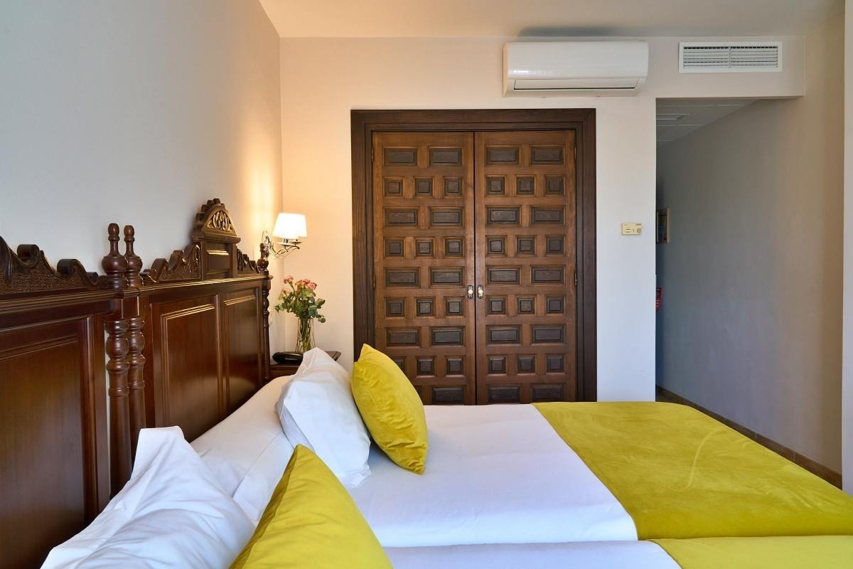 una habitación con dos camas y una puerta de madera