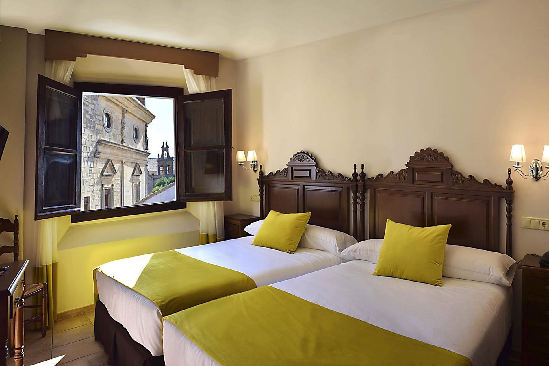 a hotel room with two beds and a window