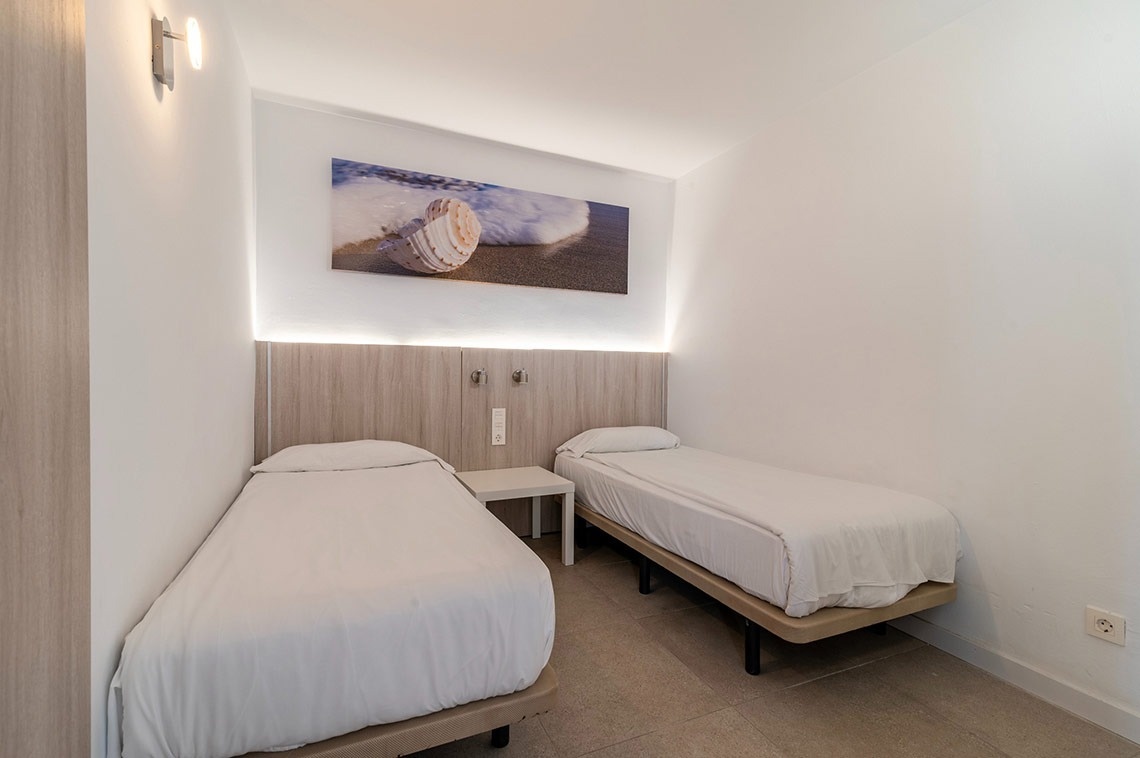 ein Schlafzimmer mit zwei Betten und einem Gemälde an der Wand