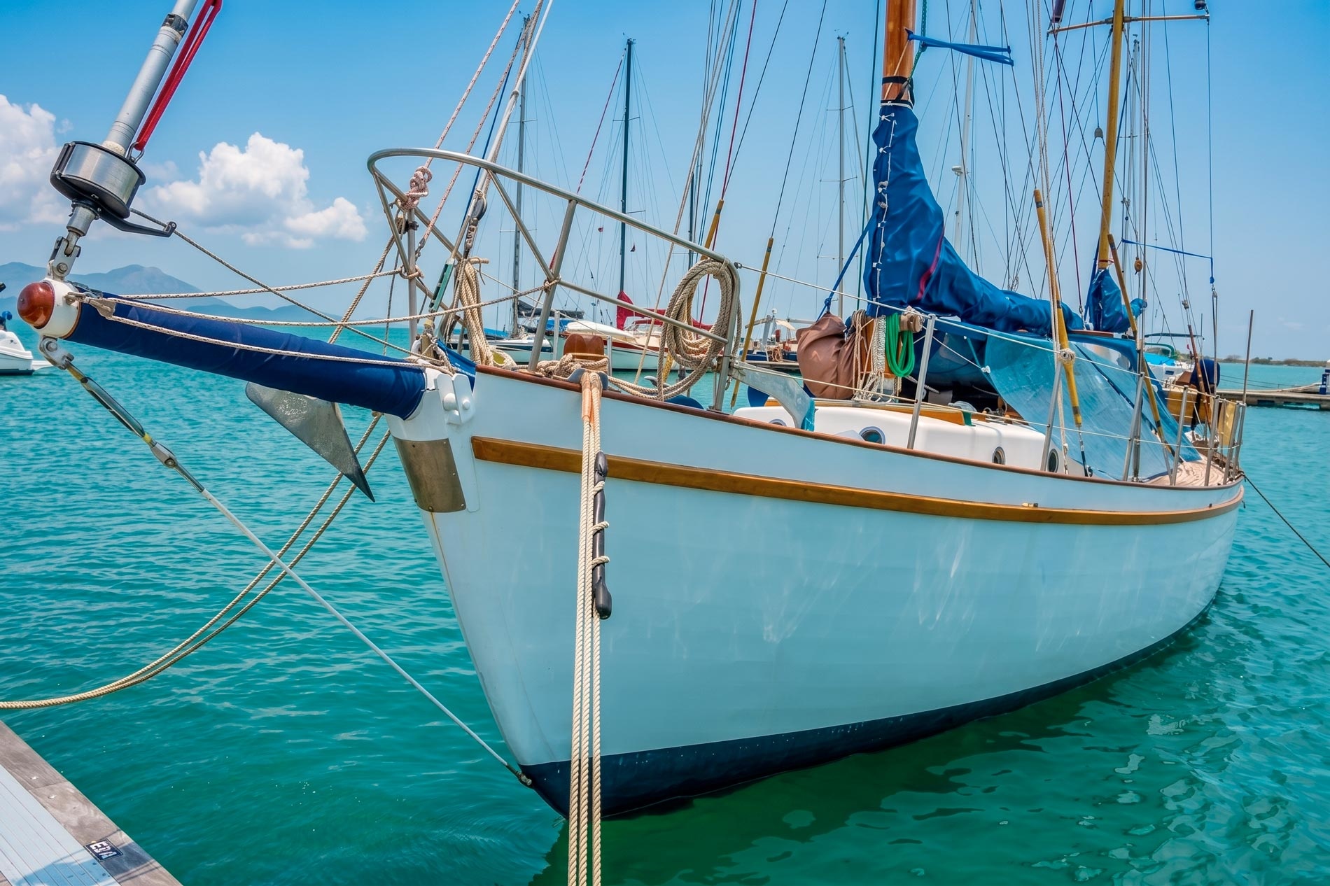 White sailboat bow at Marina Puerto Velero, turquoise waters and blue sky.