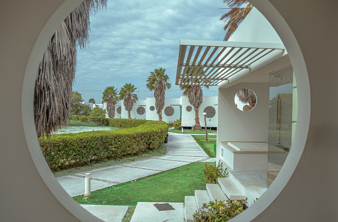 Marina Puerto Velero: exterior de hotel moderno con palmeras y diseño circular.