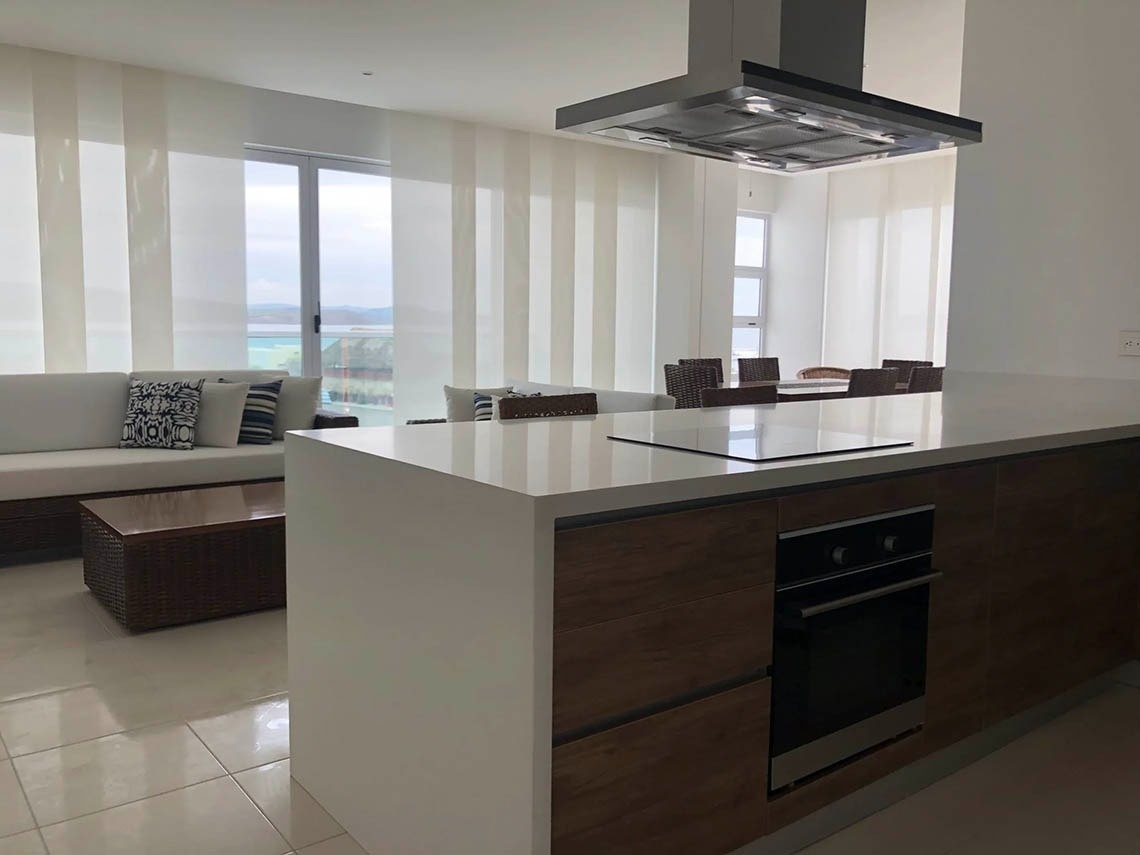 Modern kitchen with island and ocean view at Marina Puerto Velero.