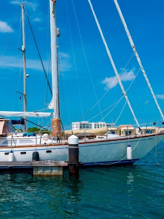 Velero de lujo en Marina Puerto Velero bajo cielo azul.