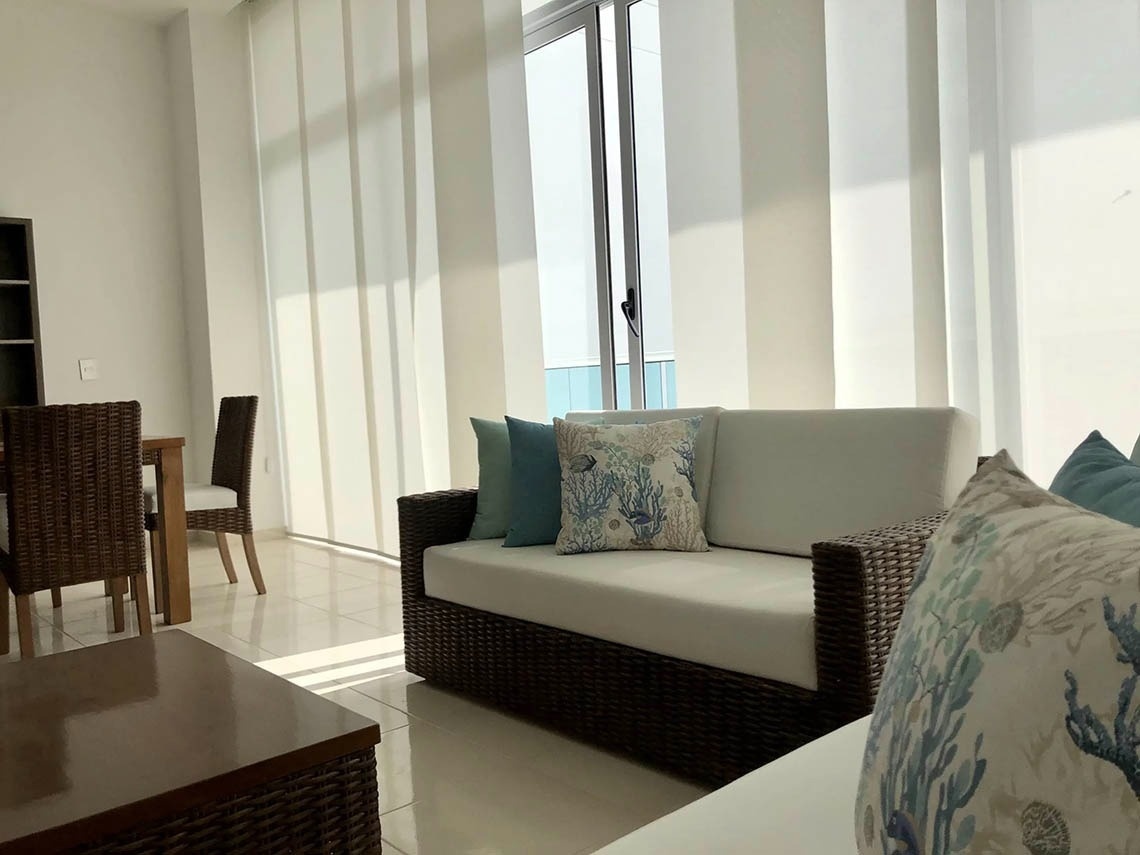 Comfortable sofa with nautical cushions, Marina Puerto Velero living room.