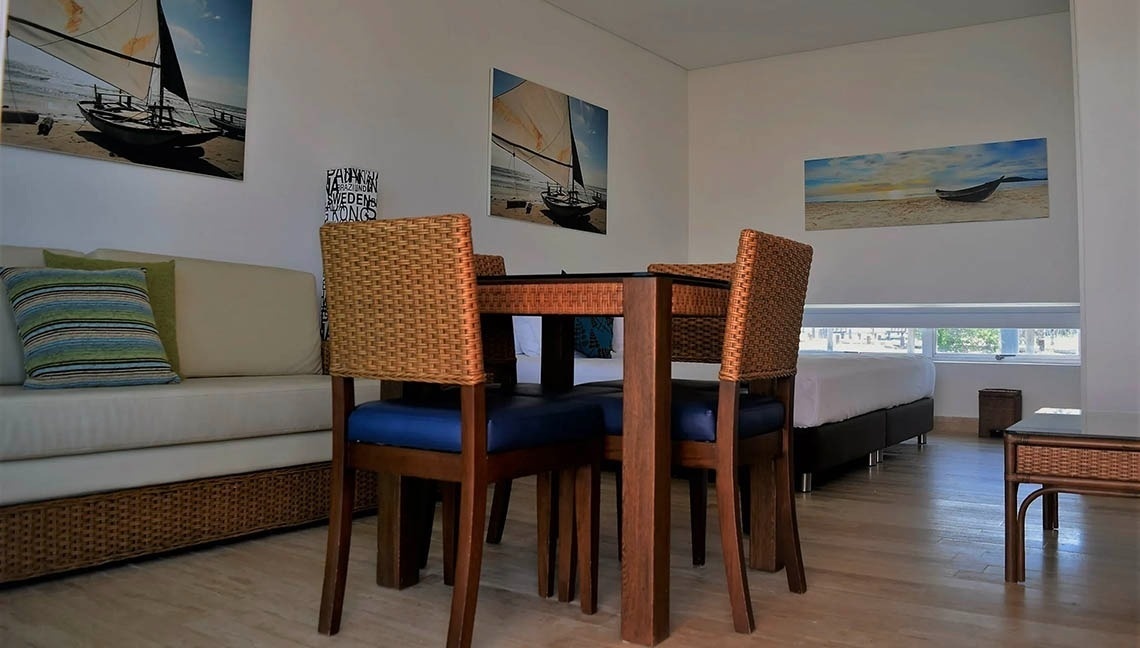 Living area with nautical art and dining table at Marina Puerto Velero.