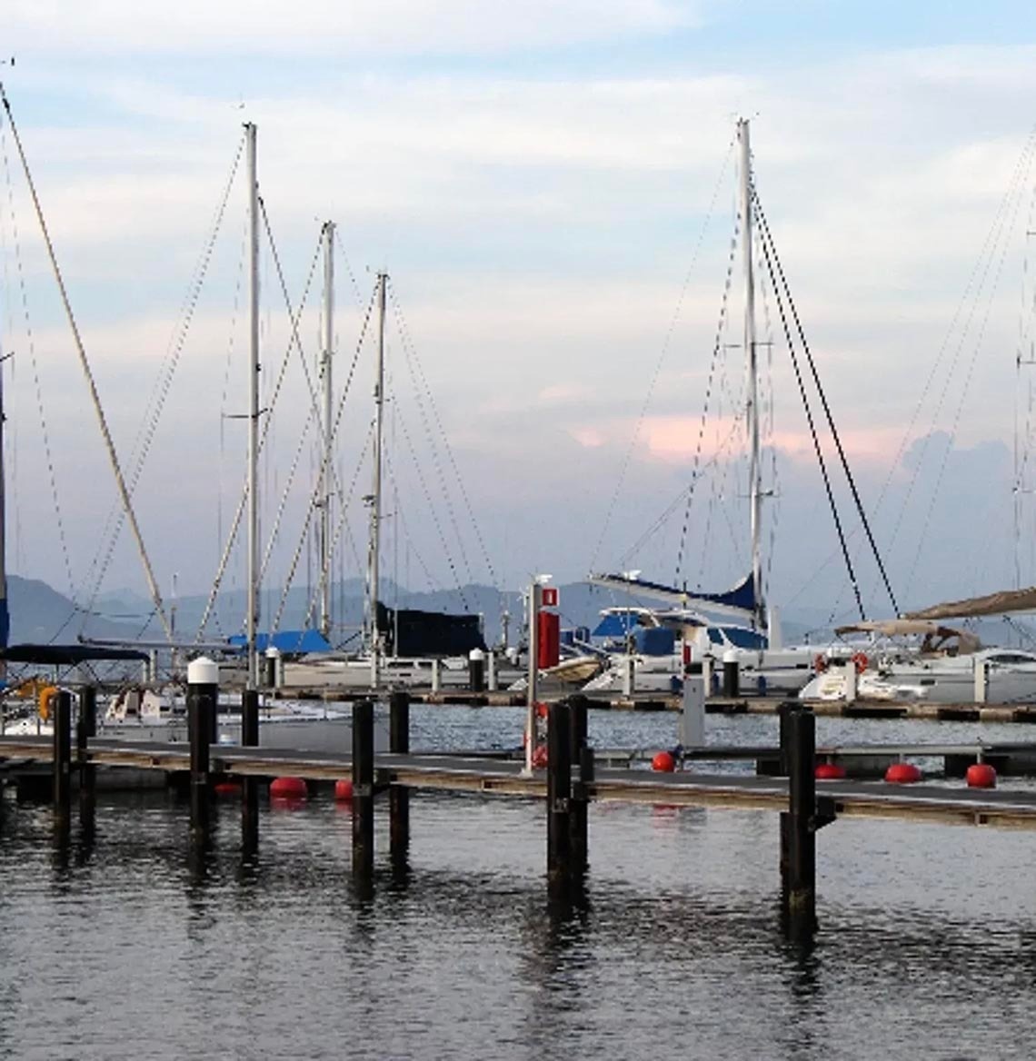 Yachts and sailboats docked at Marina Puerto Velero, a serene waterfront with calm waters.